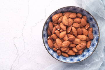 Close up of almond nuts in a bowl on table 