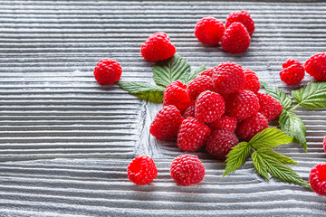 juicy fresh natural raspberries on a gray wooden rustic background