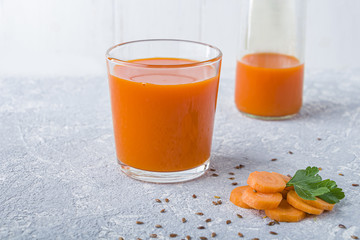 Nutritious detox carrot juice in glass with flaxed seeds and leaves of parsley. Alkaline diet concept. Organic vegetarian drink. Healthy eating. Flat lay, copy space for text