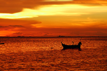 sunset red orange yellow cloud on sky and fishing boat are on sea
