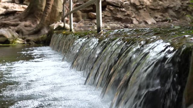 Water flowing close-up 4K footage, Natural background.