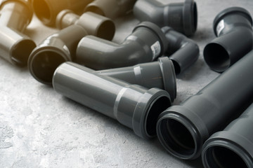 Fototapeta premium Plumbing pipes background. Sewerage water pipes on a concrete.
