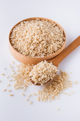 raw brown rice on white acrylic background