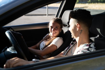 Happy smiling couple on vacation trip in car