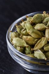 fragrant green cardamom on a dark stone background