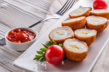 Scotch egg meat balls on rustic wooden background