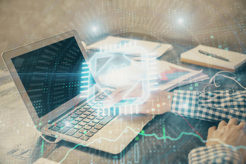 Businessman with computer background with technology theme hologram. Concept of hightech. Multi exposure.