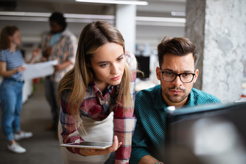 Programmers cooperating at IT company developing apps