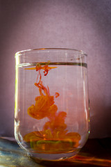a glass of water in which orange drink is added