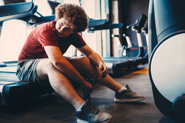 Tired fat man thinking over weight problems, desire to lose weight, gym workout