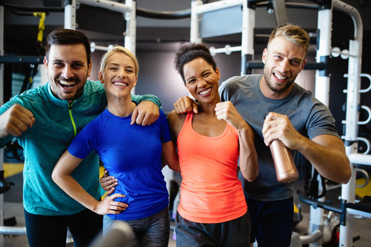 Group of young friends people doing exercises in gym