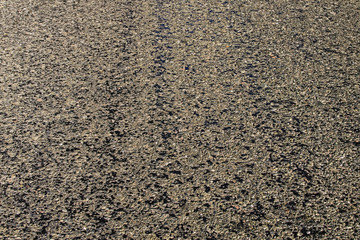 Close-up view of old asphalt. Texture black asphalt road. Surface grunge rough of asphalt. Driveway texture. Asphalt as abstract background. Tarmac road texture