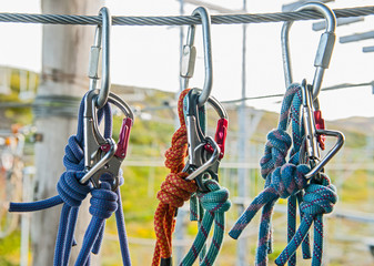 close up of carabiners on a metal wire at high rope obstacle course