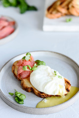 Toast with salmon, poached egg and basil. Morning and Breakfast. Healthy nutrition. Selective focus