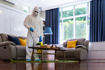Asian man in PPE disinfection from COVID-19 at home