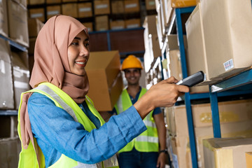 Asian Islam Muslim warehouse worker do inventory