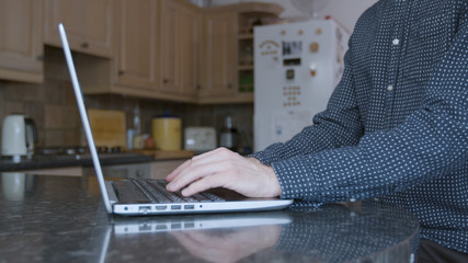 Male professional working from home in the kitchen