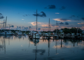 Predawn at the dock with sailboats on calm waters