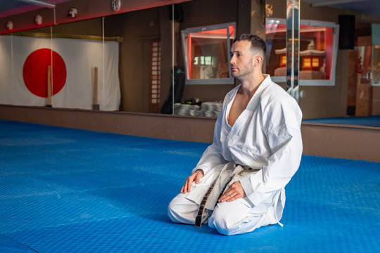 Karate man with traditional Japanese sitting posture on tatami