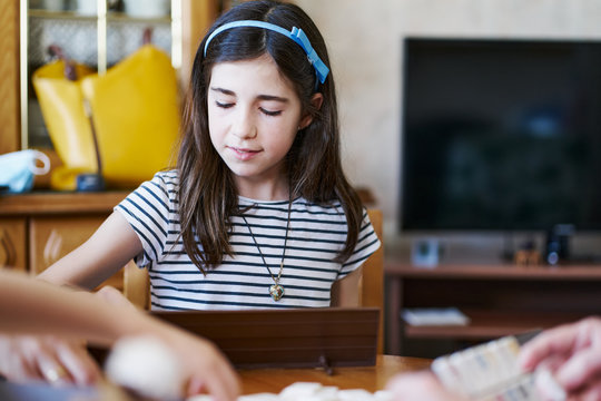 girl playing board games at home