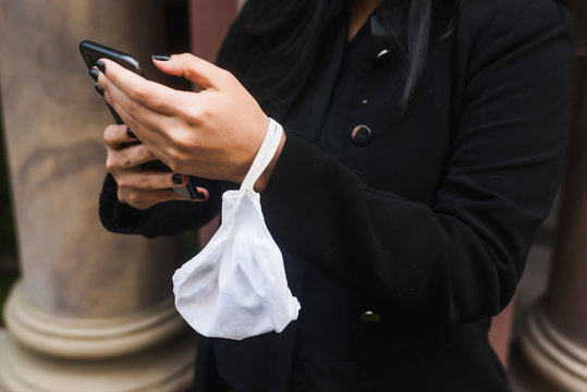 Midsection of businesswoman text messaging on smartphone