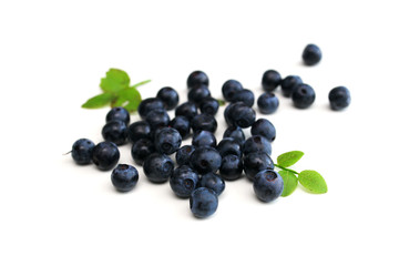 a handful of wild berries on a white table, blueberries