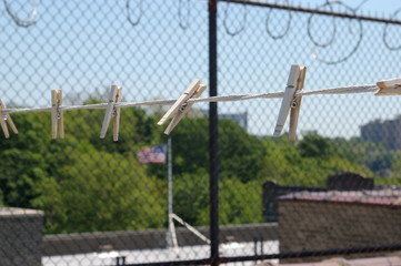 clothes line on roof of city building with american flag in background