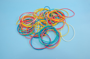 Colored rubber bands for money on a blue background. Stationery