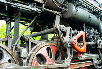 Close-up photo of the Old Steam train engine and wheels  