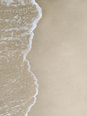 Bubble of sea water on left side of the beach with copy space. Top view