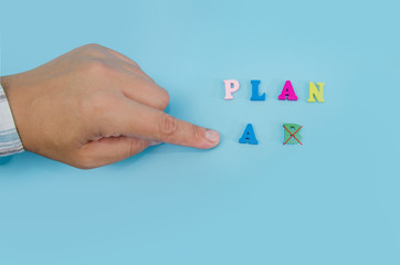 Business woman's hand points to PLAN A on a blue background. Business plan concept.