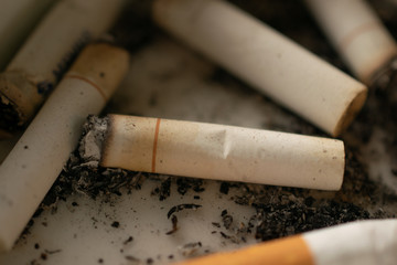 Close up of burnt cigarette in the ash trash , Smoking idea , Unhealthy concept