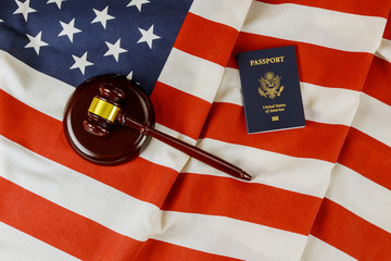 US Passports with wooden judge gavel on American flag on legal world immigration