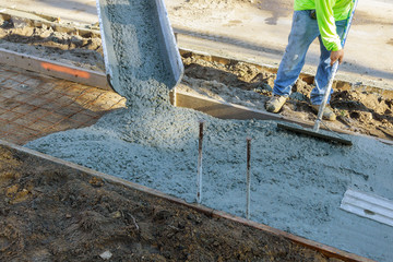 Worker plastering the concrete cement during sidewalk