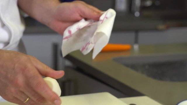 Chef drying vegetables with kitchen paper, close up