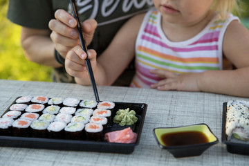 woman and child eating sushi