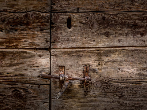 detail of an old wooden door with metal fittings