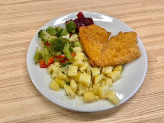 Heart Shaped Schnitzel with Marmalade Jam Sauce and Broccoli Vegetables Served with Tray at Restaurant.