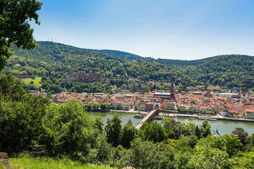 Fototapeta na wymiar Panoramic view of the old town of Heidelberg with famous Heidelberg Castle on a beautiful sunny day with blue sky and clouds in springtime, Baden-Wuerttemberg, Germany