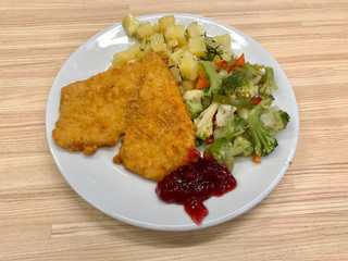 Heart Shaped Schnitzel with Marmalade Jam Sauce and Broccoli Vegetables Served with Tray at Restaurant.