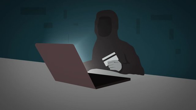 Unknown hacker holds credit card while use laptop