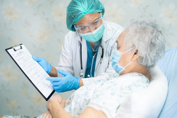 Asian doctor wearing face shield and PPE suit new normal to check patient protect safety infection...