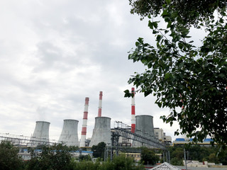 Cooling towers in the city. Boiler room. Industrial air pollution.