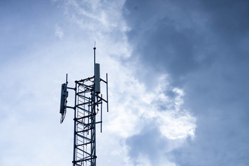 Telecommunication Radio Base and Cellular antenna with clouds on background.
