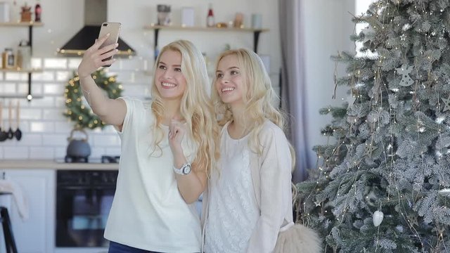 Girls make a video greeting Happy New Year and Mary christmas