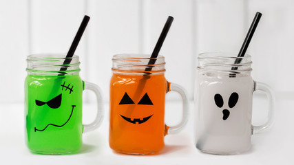Cute Halloween drinks for a kids party. Three cocktails on white background