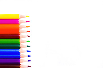 Colorful pencils on white background, side border from top view. School & office concept. Empty space for text.