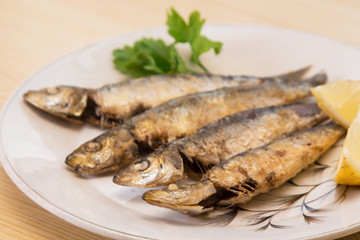 grilled sardines with lemon and parsley on the plate