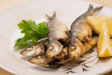 grilled sardines with lemon and parsley on the plate
