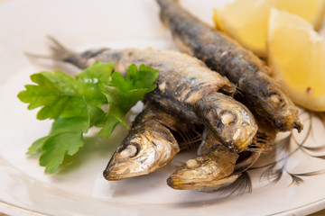grilled sardines with lemon and parsley on the plate